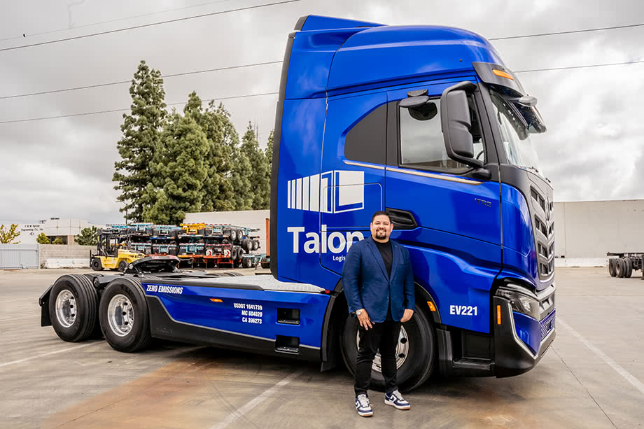 Emmanuel Carrillo standing in front of a Talon Logistics truck cab