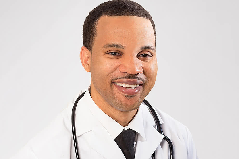 Dr. Kumapley Lartevi in a white coat and tie